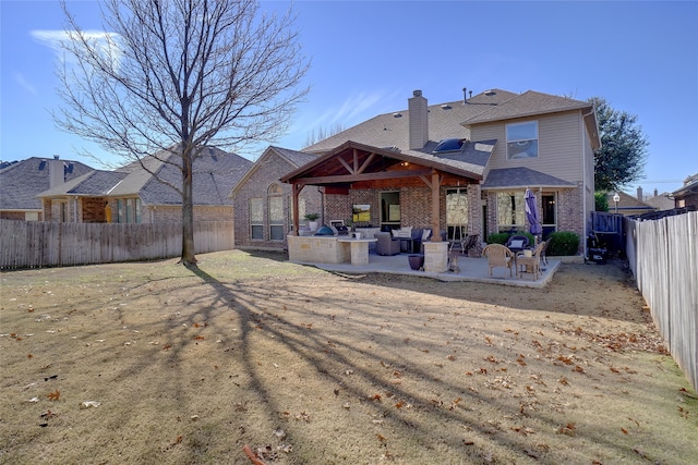 rear view of property featuring a patio area