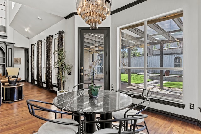 dining area featuring plenty of natural light, vaulted ceiling, and hardwood / wood-style floors