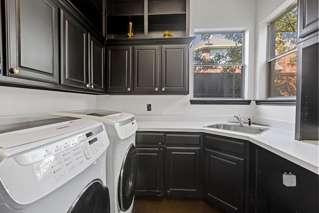 laundry room featuring cabinets, sink, and independent washer and dryer