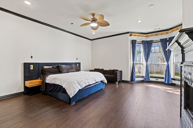 bedroom featuring crown molding, ceiling fan, hardwood / wood-style floors, and a baseboard heating unit