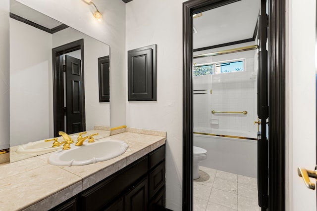 full bathroom with combined bath / shower with glass door, vanity, ornamental molding, tile patterned floors, and toilet