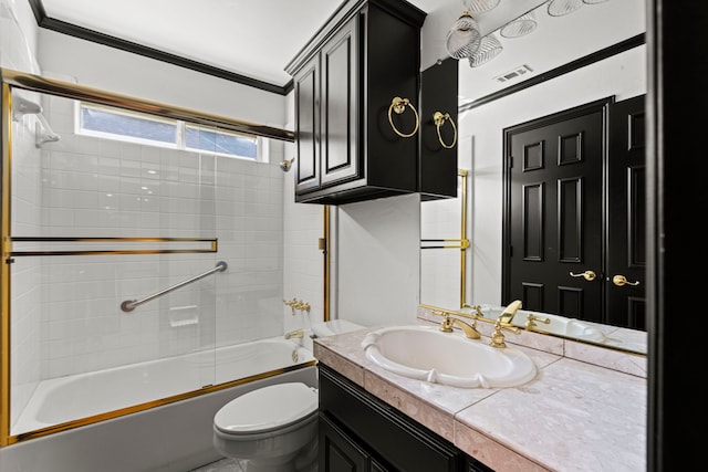 full bathroom featuring vanity, ornamental molding, shower / bath combination with glass door, and toilet