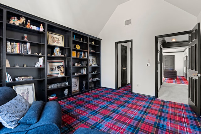 living area featuring lofted ceiling and dark carpet