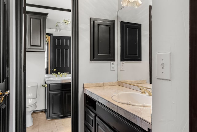 bathroom featuring vanity, tile patterned floors, and toilet