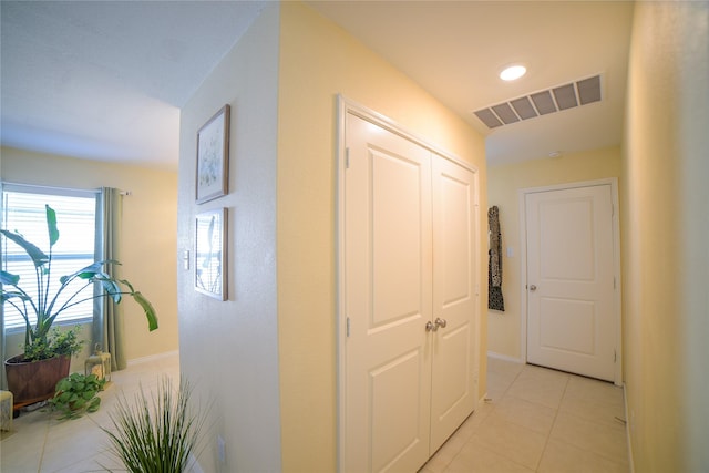 hall featuring light tile patterned flooring