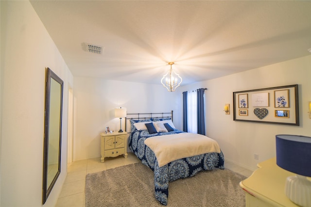 bedroom featuring light tile patterned flooring and a chandelier