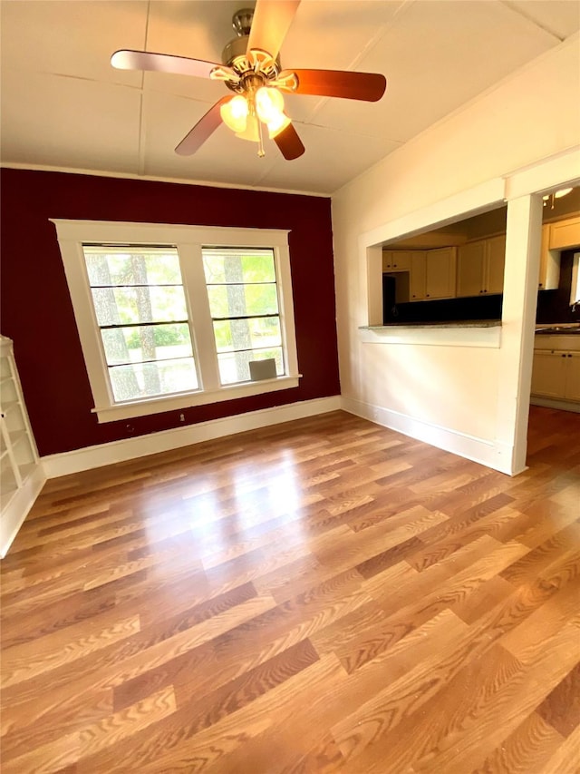 unfurnished living room featuring light hardwood / wood-style flooring and ceiling fan