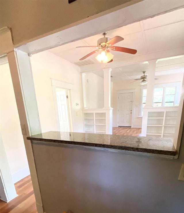 kitchen featuring beam ceiling and light hardwood / wood-style floors