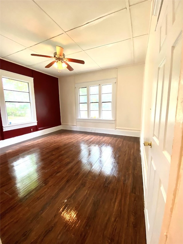 spare room with dark wood-type flooring and ceiling fan