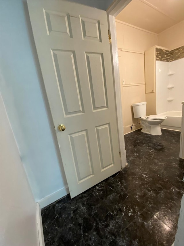 bathroom with washtub / shower combination and toilet