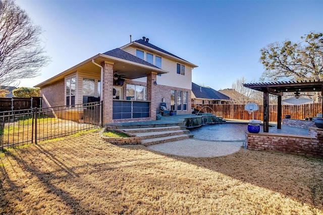 rear view of property with a patio, a swimming pool, ceiling fan, and a pergola