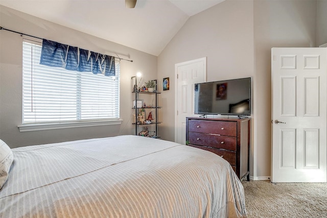 carpeted bedroom featuring ceiling fan and vaulted ceiling