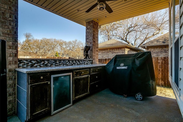 view of patio with area for grilling, beverage cooler, ceiling fan, and an outdoor kitchen