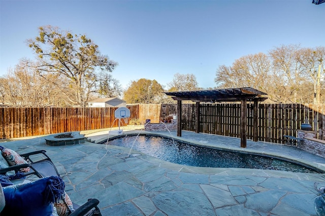 view of swimming pool featuring a patio, pool water feature, and an outdoor fire pit