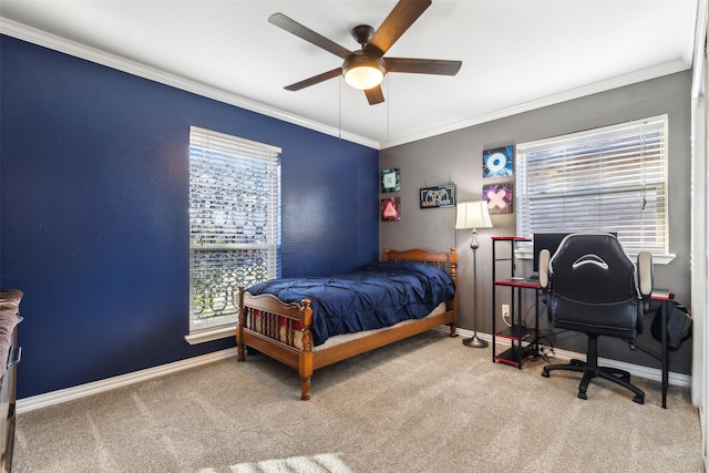 bedroom with carpet floors, ceiling fan, baseboards, and crown molding