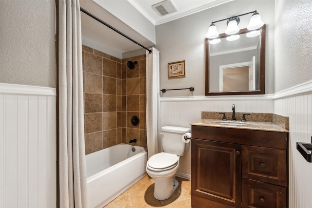 full bathroom with toilet, shower / bath combo, wainscoting, and visible vents