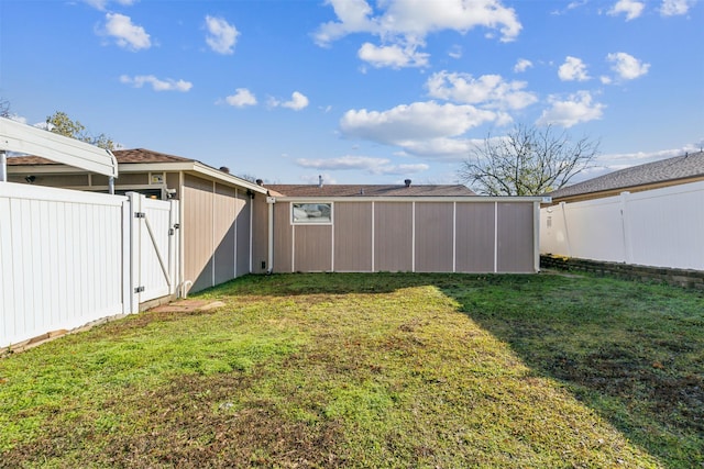 view of yard featuring a fenced backyard and a gate