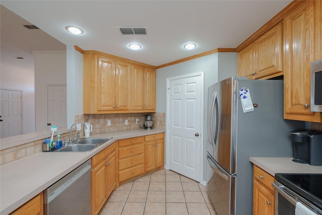 kitchen with sink, backsplash, ornamental molding, and stainless steel appliances