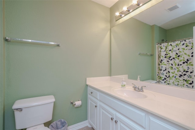 bathroom with vanity, a shower with shower curtain, and toilet