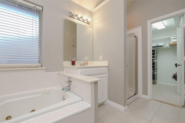 bathroom featuring independent shower and bath, vanity, and tile patterned floors