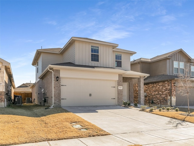 traditional-style home with brick siding, an attached garage, board and batten siding, and driveway