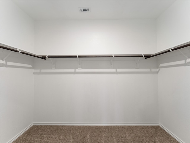 spacious closet with carpet floors and visible vents
