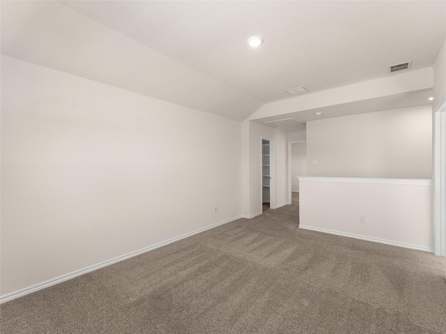 empty room featuring attic access, visible vents, carpet floors, baseboards, and recessed lighting