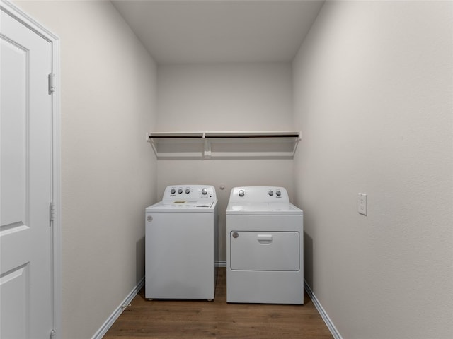 washroom with baseboards, laundry area, independent washer and dryer, and wood finished floors