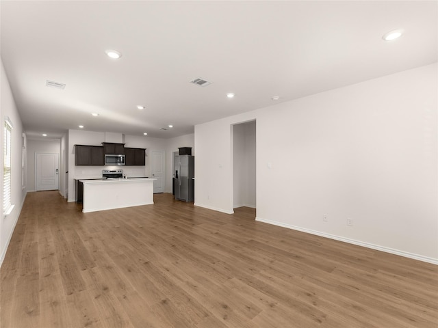 unfurnished living room featuring visible vents, recessed lighting, and light wood finished floors
