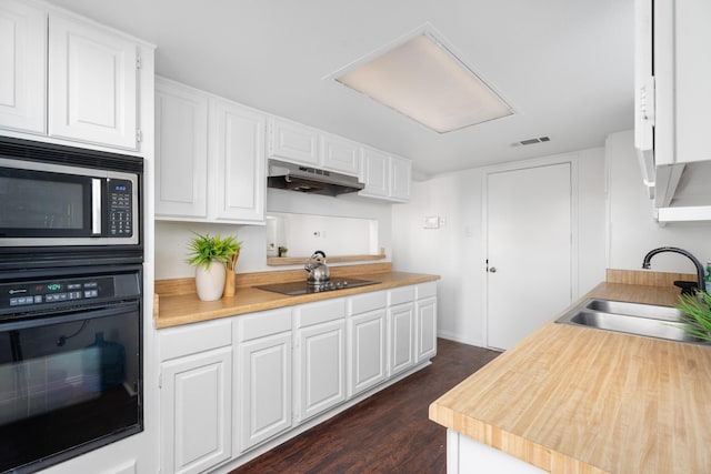 kitchen with dark hardwood / wood-style flooring, sink, black appliances, and white cabinets