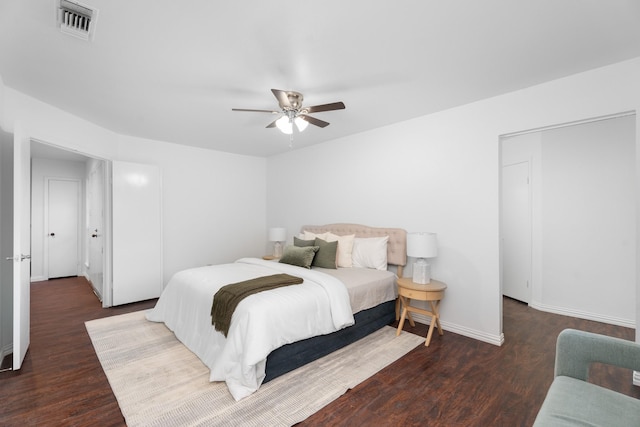 bedroom with dark hardwood / wood-style floors and ceiling fan