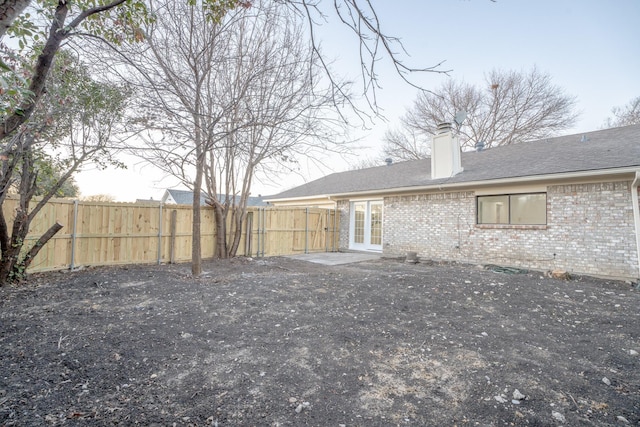 rear view of house featuring french doors