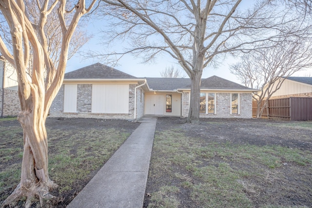 ranch-style home featuring a front yard