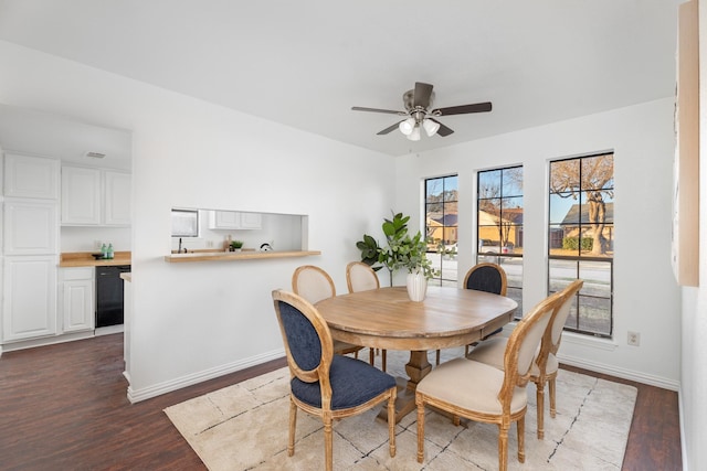 dining room with dark wood-type flooring and ceiling fan