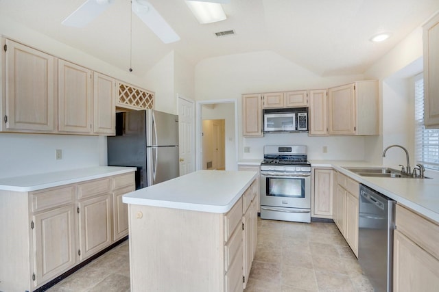 kitchen with stainless steel appliances, a kitchen island, sink, and light brown cabinets