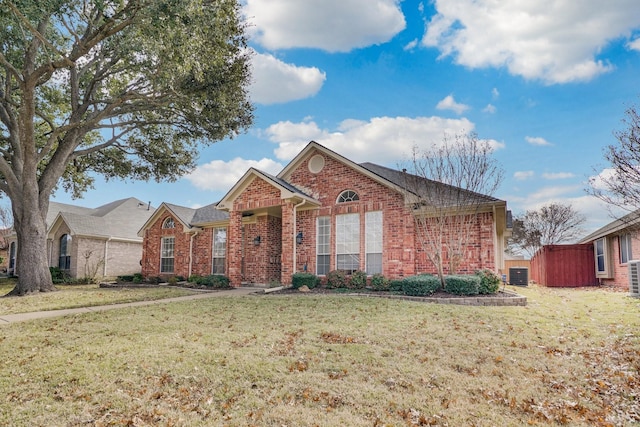 view of front of home featuring central AC and a front yard