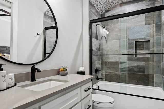 full bathroom featuring vanity, toilet, and combined bath / shower with glass door