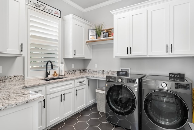 clothes washing area with sink, cabinets, ornamental molding, dark tile patterned flooring, and washing machine and dryer