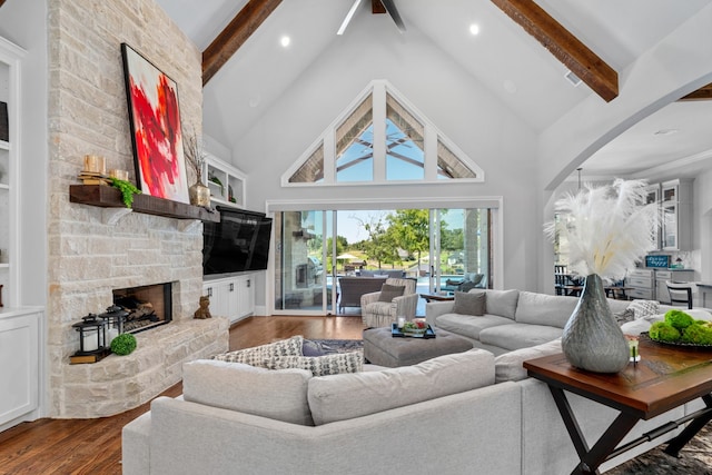 living room with wood-type flooring, a fireplace, high vaulted ceiling, and beam ceiling