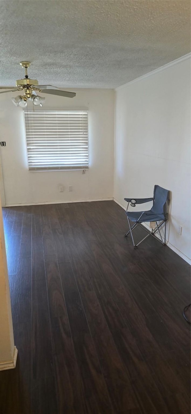 unfurnished room with dark hardwood / wood-style flooring, ceiling fan, and a textured ceiling