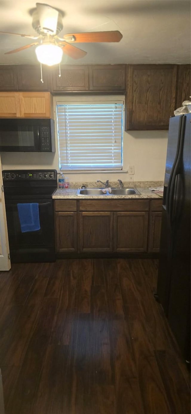 kitchen featuring ceiling fan, sink, dark hardwood / wood-style flooring, and black appliances