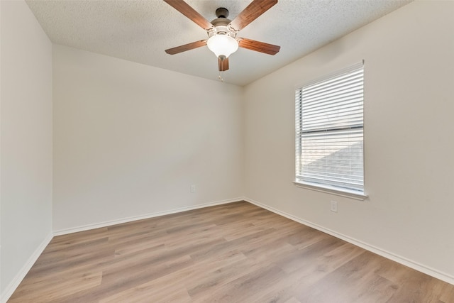 empty room featuring ceiling fan, a textured ceiling, and light hardwood / wood-style floors