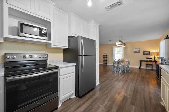 207 Granbury Ct, Granbury, TX 76049 - kitchen with appliances with stainless steel finishes, light countertops, white cabinets, dark wood-type flooring, and baseboards