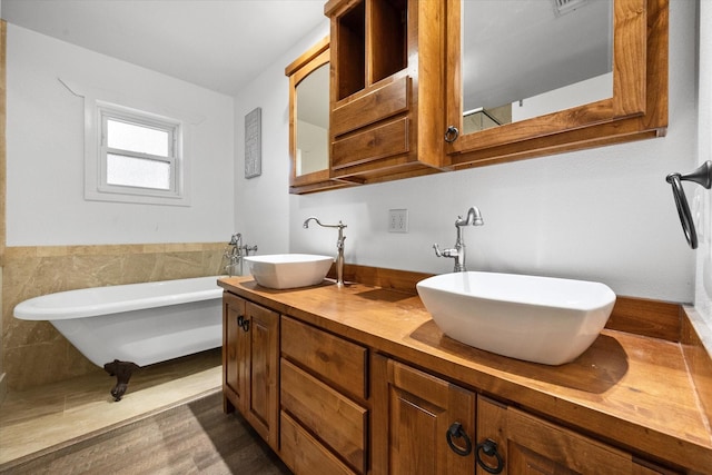 207 Granbury Ct, Granbury, TX 76049 - full bath featuring a freestanding tub, double vanity, and wood finished floors