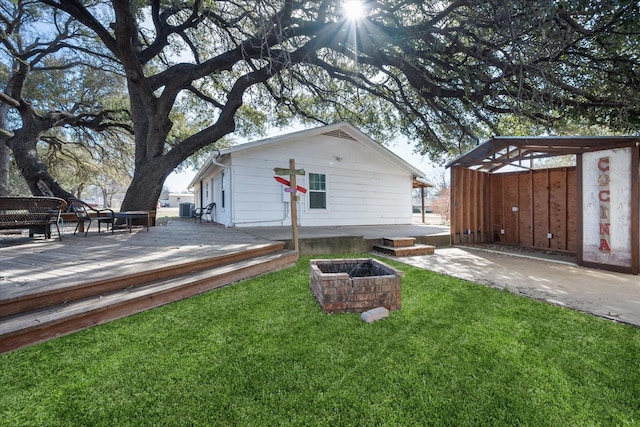 207 Granbury Ct, Granbury, TX 76049 - rear view of house featuring a lawn, a deck, central air condition unit, and an outdoor fire pit