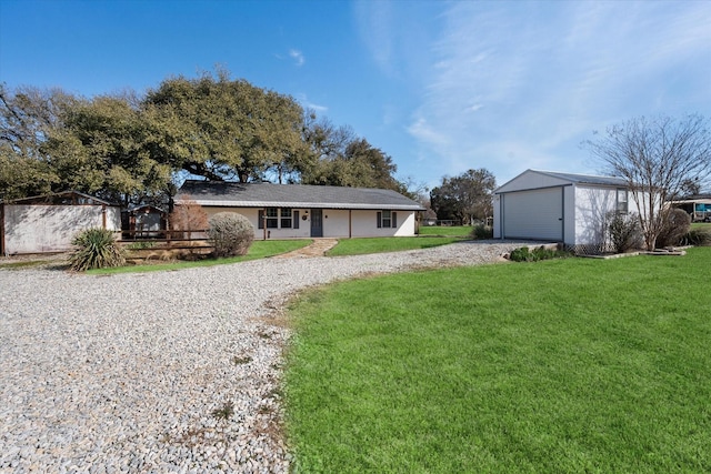 207 Granbury Ct, Granbury, TX 76049 - view of front facade with an outdoor structure, a front yard, a garage, and driveway
