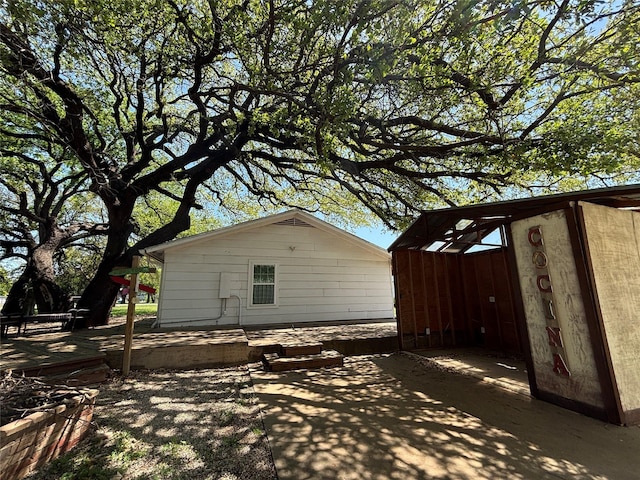 207 Granbury Ct, Granbury, TX 76049 - view of side of home featuring an outdoor structure and a patio