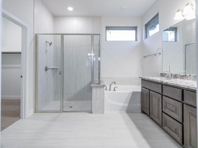 bathroom with vanity and independent shower and bath