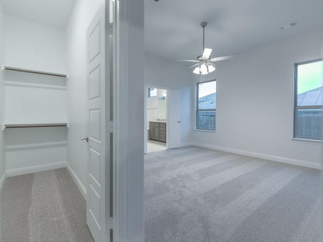 carpeted empty room with ceiling fan