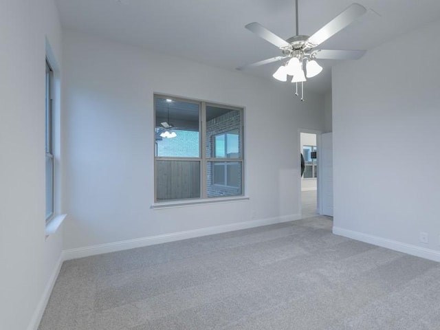 carpeted empty room featuring vaulted ceiling and ceiling fan